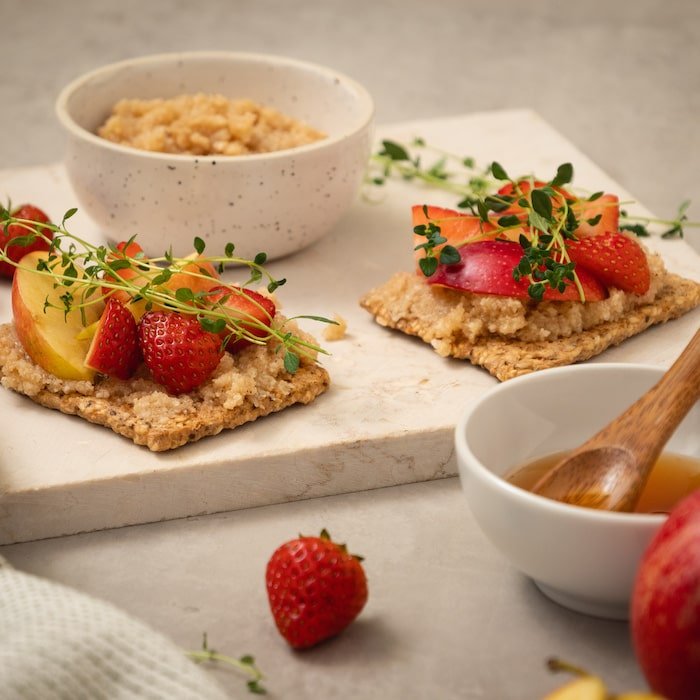 Crispbreads topped with fruits and coconut spread